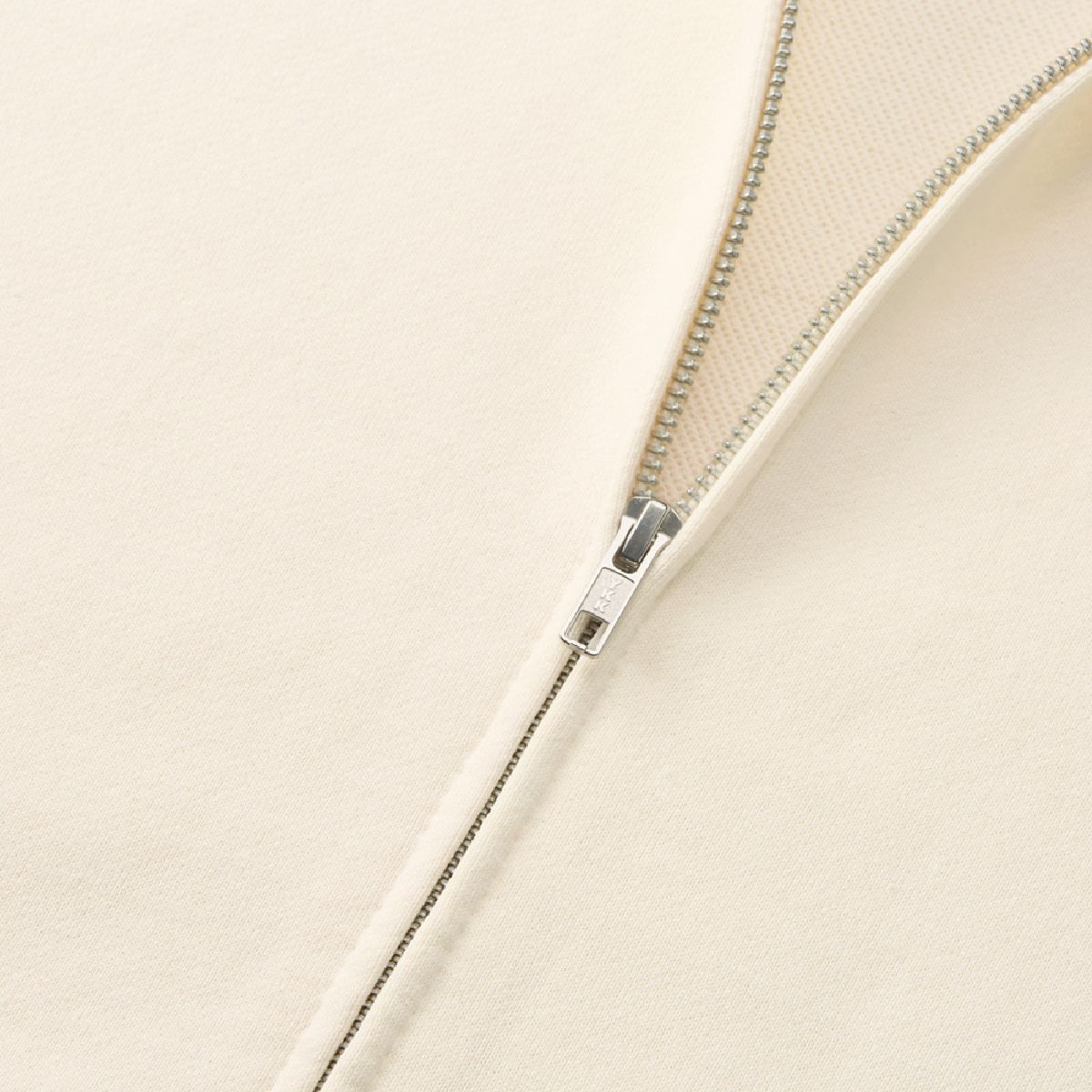 The zipper is made by YKK, with a single slider design