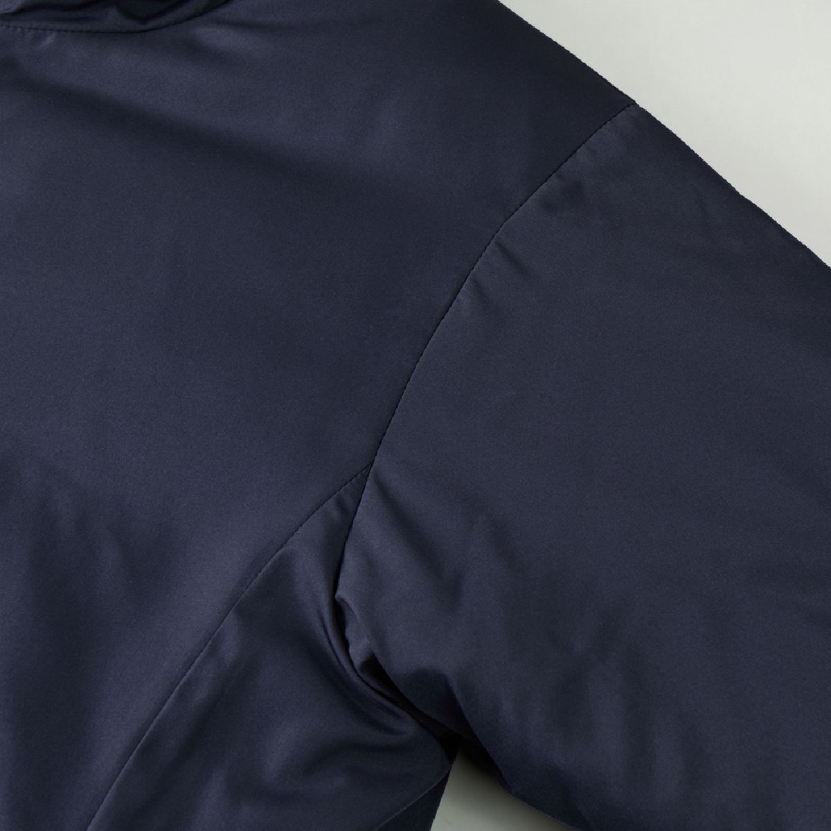 The sleeve attachment features a set-in sleeve construction.