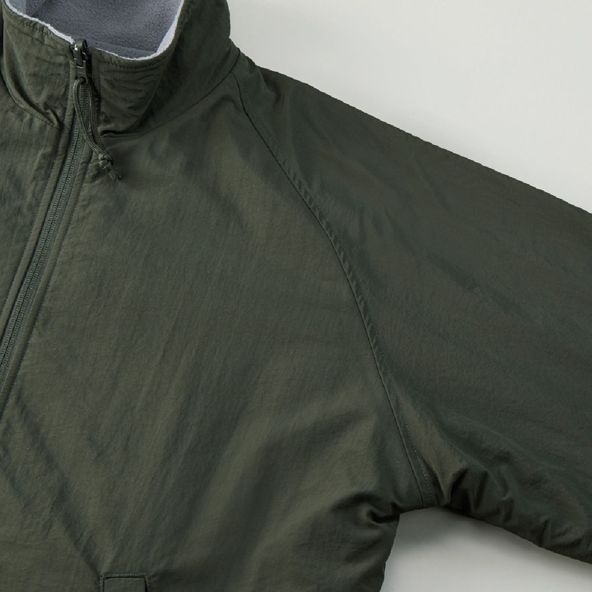 It features a raglan sleeve construction.