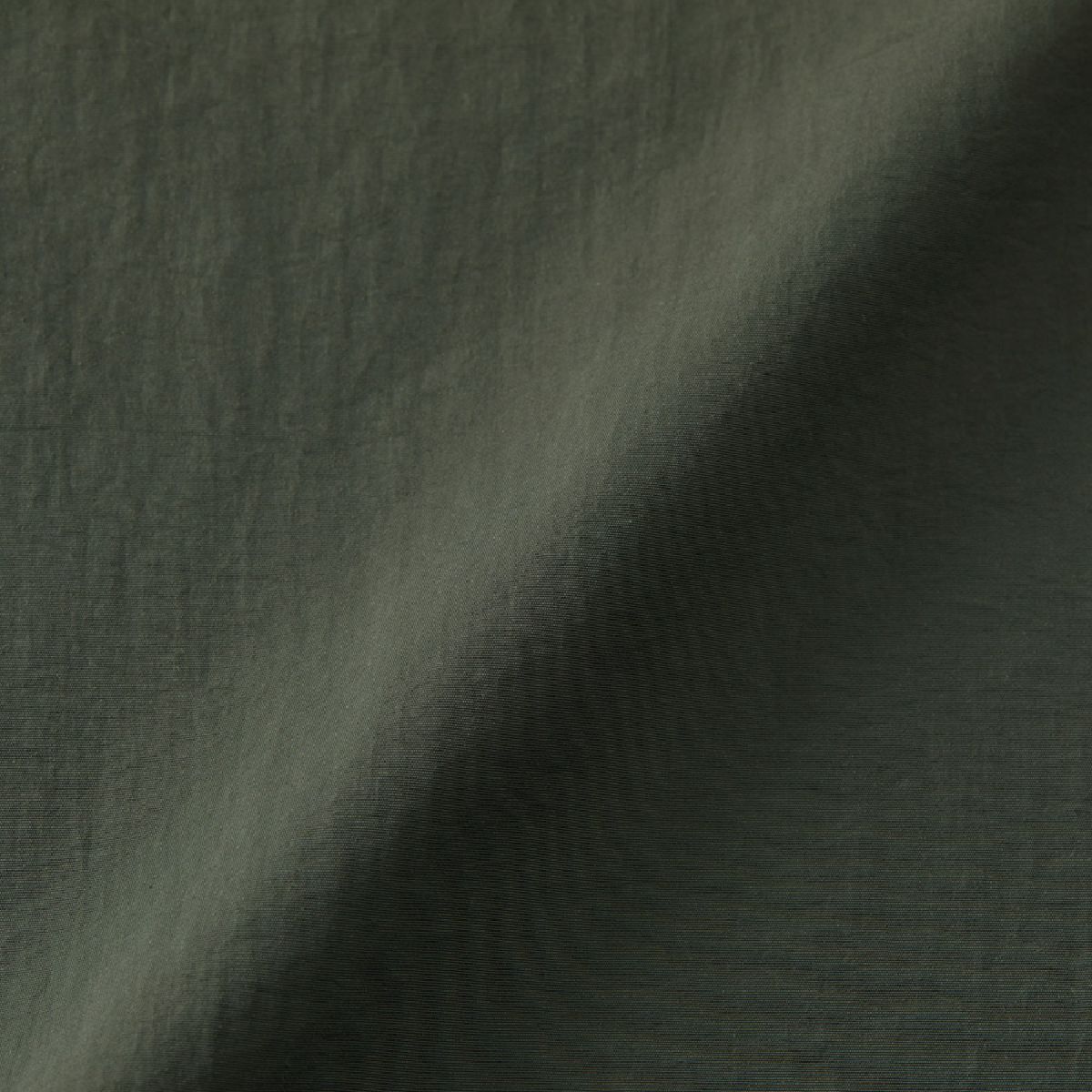 A fabric that is 100% nylon yet has the look and feel of cotton (nylon side).