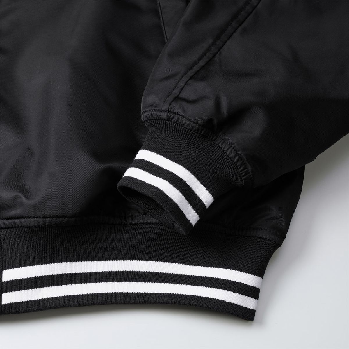 The cuffs and hem feature a snug ribbed finish; color numbers 2001 and 4001 feature striped ribbing.